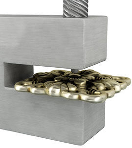  A metal component in the die opening of a steel hole punch.